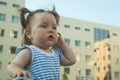 Portrait of a little hurt girl outdoors in summer day.