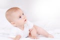 Portrait of little infant lies on a white bed in bedroom Royalty Free Stock Photo