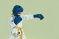 Portrait of little karate girl in white kimono wearing gloves and protective helmet, looking focused at camera, ready to Royalty Free Stock Photo