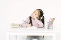Portrait of little kid Asian schoolgirl sitting at desk handwrite in notebook having distant class, Asia kid prepare homework