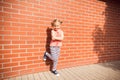 Portrait of little kid girl laughing at bricks wall background Royalty Free Stock Photo