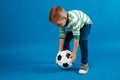 Portrait of a kid going to kick a soccer ball Royalty Free Stock Photo