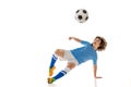 Portrait of little male football soccer player, boy training with football ball isolated on white studio background Royalty Free Stock Photo