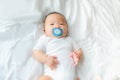 Portrait of little newborn baby boy laying with pacifier on mouth Royalty Free Stock Photo