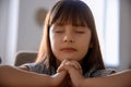 Portrait of little praying girl