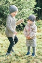 portrait of little preschool brother trying to cheer up shy toddler sister