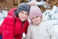 Portrait of little preschool girl and school boy playing with snow in winter. Brother and cute sister together during Royalty Free Stock Photo