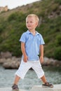 Portrait of little pretty boy on beach, summer