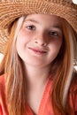 Portrait of little red-haired girl with freckles and a straw hat Royalty Free Stock Photo