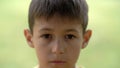 Portrait of little sad desperate kid looking at camera, close up Royalty Free Stock Photo