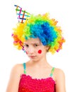 Portrait of little sad girl in clown wig isolated on white backg Royalty Free Stock Photo