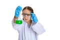 Portrait of little school girl, kid in white big gown as chemist, scientist doing experiment with multicolored chemical Royalty Free Stock Photo