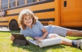 Portrait of little schoolboy writing outdoor in school park and doing homework. Royalty Free Stock Photo