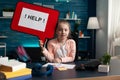 Portrait of little schoolchild holding help banner