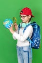Portrait of a little schoolgirl with a backpack holding a globe in her hands Royalty Free Stock Photo