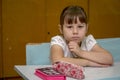 Portrait of a little schoolgirl at a school desk