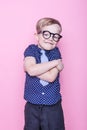 Portrait of a little smiling boy in a funny glasses and tie. School. Preschool. Fashion. Studio portrait over pink background Royalty Free Stock Photo