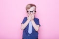 Portrait of a little smiling boy in a funny glasses and tie. School. Preschool. Fashion. Studio portrait over pink background Royalty Free Stock Photo