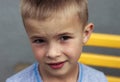 Portrait of a little smiling boy with golden blonde straw hair i Royalty Free Stock Photo