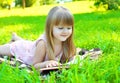 Portrait of little smiling girl child reading a book Royalty Free Stock Photo