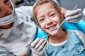 Portrait of a little smiling girl at dentist office