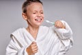 Portrait of little teen boy brushing teeth at morning. Child hygiene and healthcare.