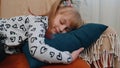 Little teen children girl sleeping, resting, enjoying carefree peaceful weekend, on couch at home Royalty Free Stock Photo