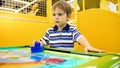 Portrait of little toddler boy playing in air hockey Royalty Free Stock Photo