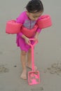 Portrait of  little toddler girl playing sand at the beach Royalty Free Stock Photo