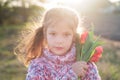 Portrait in the lock flower careglase of a girl with tulips near her face. Spring evening walk Royalty Free Stock Photo