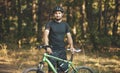 Portrait of a lone cyclist training in the forest. Mountain biking off-road