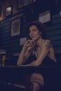 Portrait of a lone woman at a bar