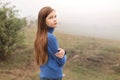 Portrait of a long-haired girl walking in a foggy morning Royalty Free Stock Photo