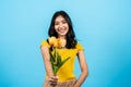 portrait, long haired girl wearing shirt yellow tights, She held bouquet yellow lilies in his hand, With shy look,