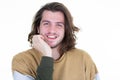 Portrait of long haired handsome young man smiling against white background Royalty Free Stock Photo