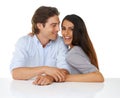 Portrait, love and couple smile together in studio with white background and hand holding. Sitting, studio and face of a Royalty Free Stock Photo