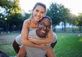 Portrait, love and piggyback with an interracial couple together outdoor in a park for bonding or a date. Summer Royalty Free Stock Photo