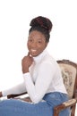 A portrait of a lovely black female sitting in an old arm chair Royalty Free Stock Photo