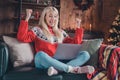 Portrait of lovely cheerful girl sitting using laptop rejoicing having fun at home modern loft industrial interior