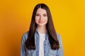 Portrait of lovely cheerful positive girl on yellow background