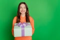 Portrait of lovely cute lady receive present look empty space on green background