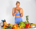 Portrait of  a lovely fitness blonde woman with heap Of vegetables. Isolated. Royalty Free Stock Photo