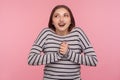 Portrait of lovely happy woman in striped sweatshirt dreaming and fantasizing, having pleasant memories Royalty Free Stock Photo