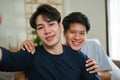 A portrait of a lovely and happy young Asian gay couple at home, hugging each other Royalty Free Stock Photo