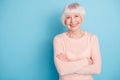 Portrait of lovely lady with her arms folded having toothy smile wearing pastel sweater isolated over blue background Royalty Free Stock Photo