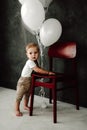 Portrait of lovely little boy happy smiling celebrating 1 year birthday. One year old european boy sitting on floor Royalty Free Stock Photo