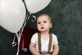 Portrait of lovely little boy happy smiling celebrating 1 year birthday. One year old european boy sitting on floor Royalty Free Stock Photo