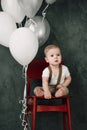 Portrait of lovely little boy happy smiling celebrating 1 year birthday. One year old european boy sitting on floor Royalty Free Stock Photo