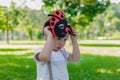 Portrait lovely little boy in the park. Attractive handsome young boy is putting the mask for playing in garden in evening. Lovely