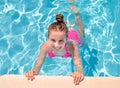 Teen girl in swimming pool squinting her eyes